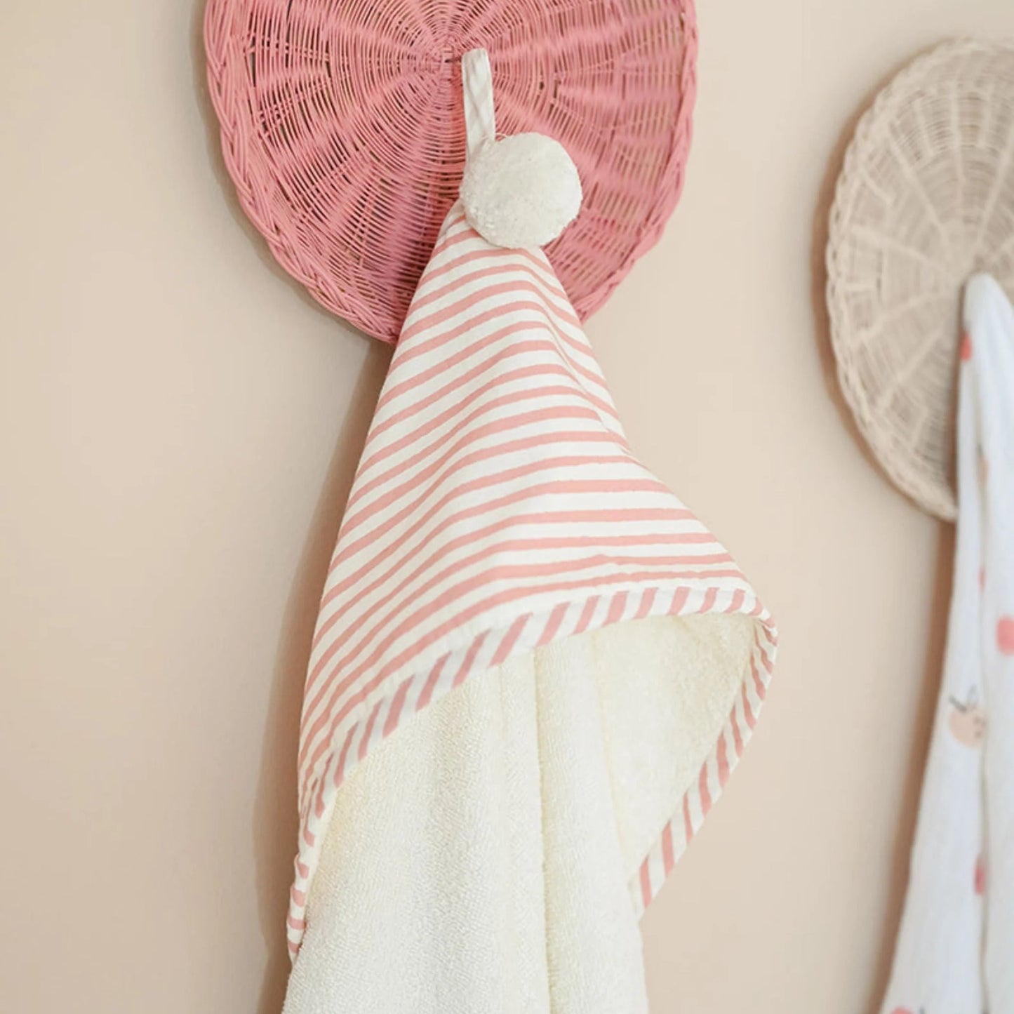 Pehr Stripes Away Petal hooded towel featuring colorful striped design and a cozy hood for drying and wrapping a pet or child.