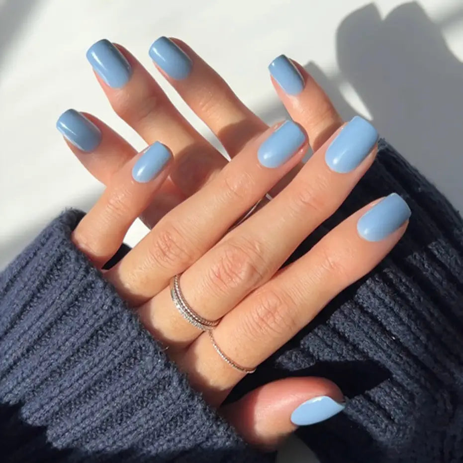 Glamnetic cashmere blue press-on nails with elegant, glossy finish and detailed design, perfect for short, stylish manicure.