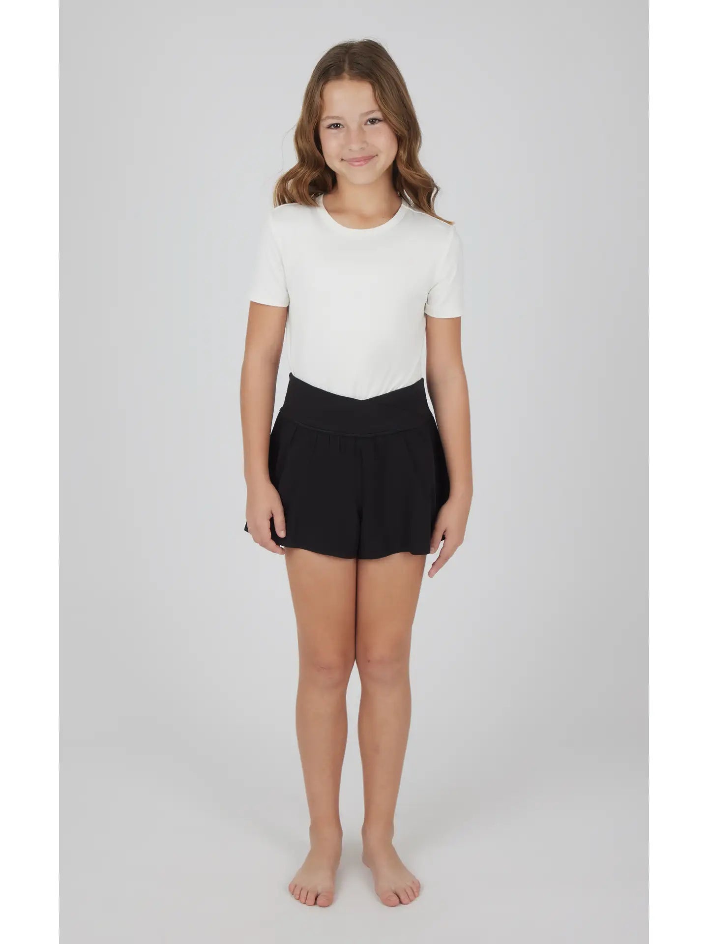 Black Girls Crossover Hybrid Shorts with Inner Pant by 90 Degree by Reflex, featuring a black color, crossover design, and built-in inner pant.