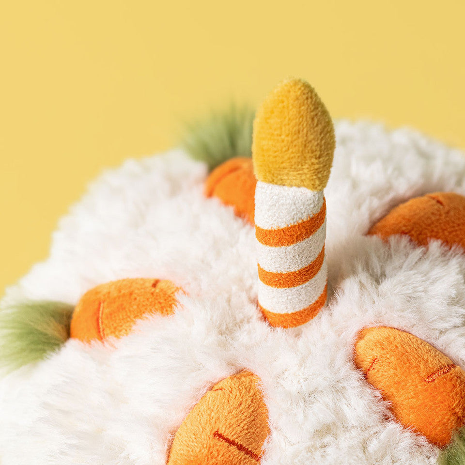 Jellycat Amuseables Carrot Cake plush toy with orange and green fabric, soft and cuddly, designed as a cute carrot cake character.