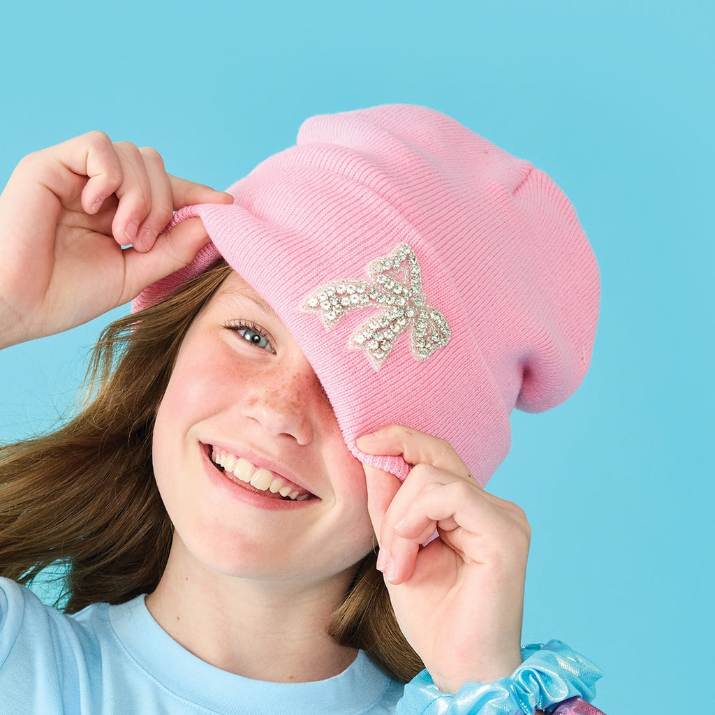Pink bow beanie hat for children from Iscream, featuring a cute bow detail, perfect for keeping kids warm and stylish.