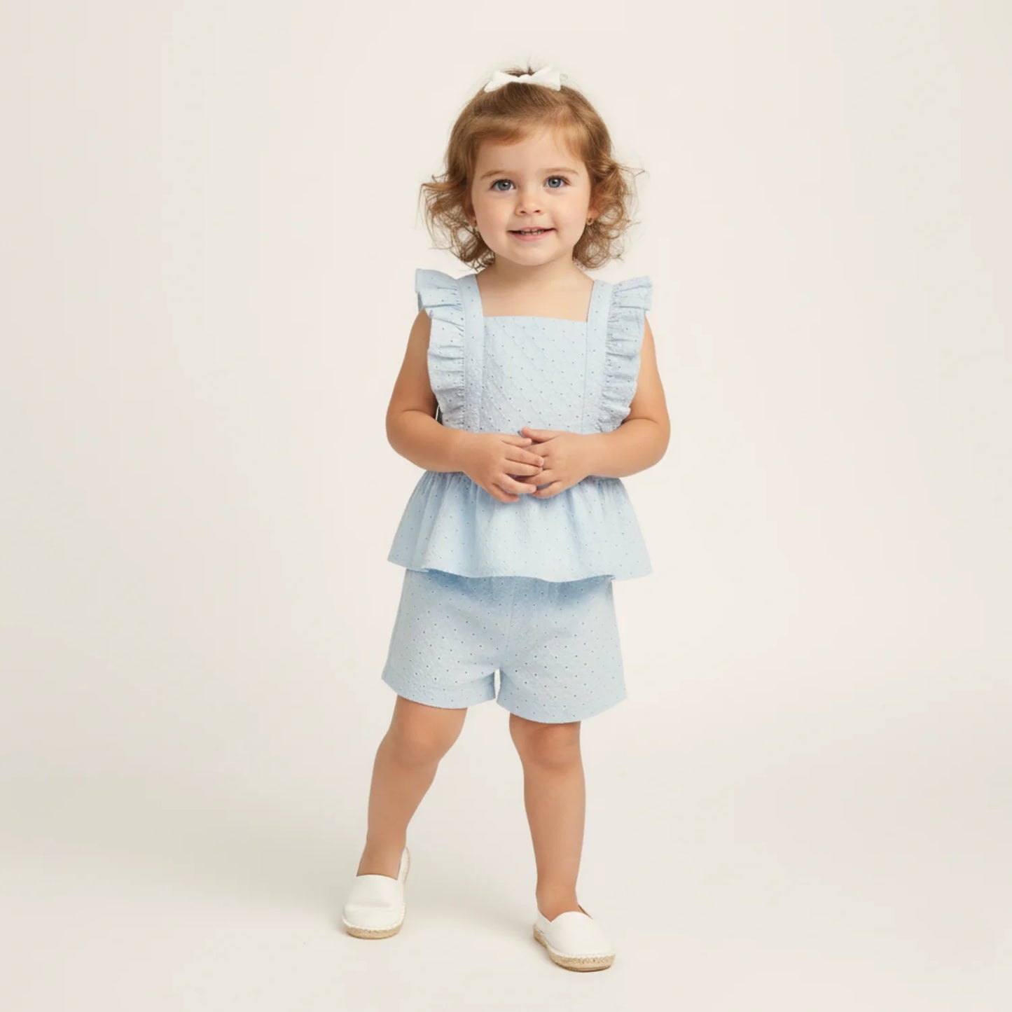 Light blue eyelet flutter top and shorts set by MakeMake, featuring delicate eyelet details and a breezy, stylish design.