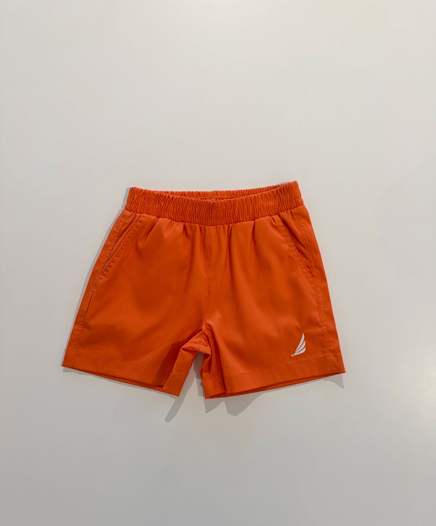 Solid orange River Performance shorts by Coolybri, featuring a comfortable fit and athletic design, shown on a model.