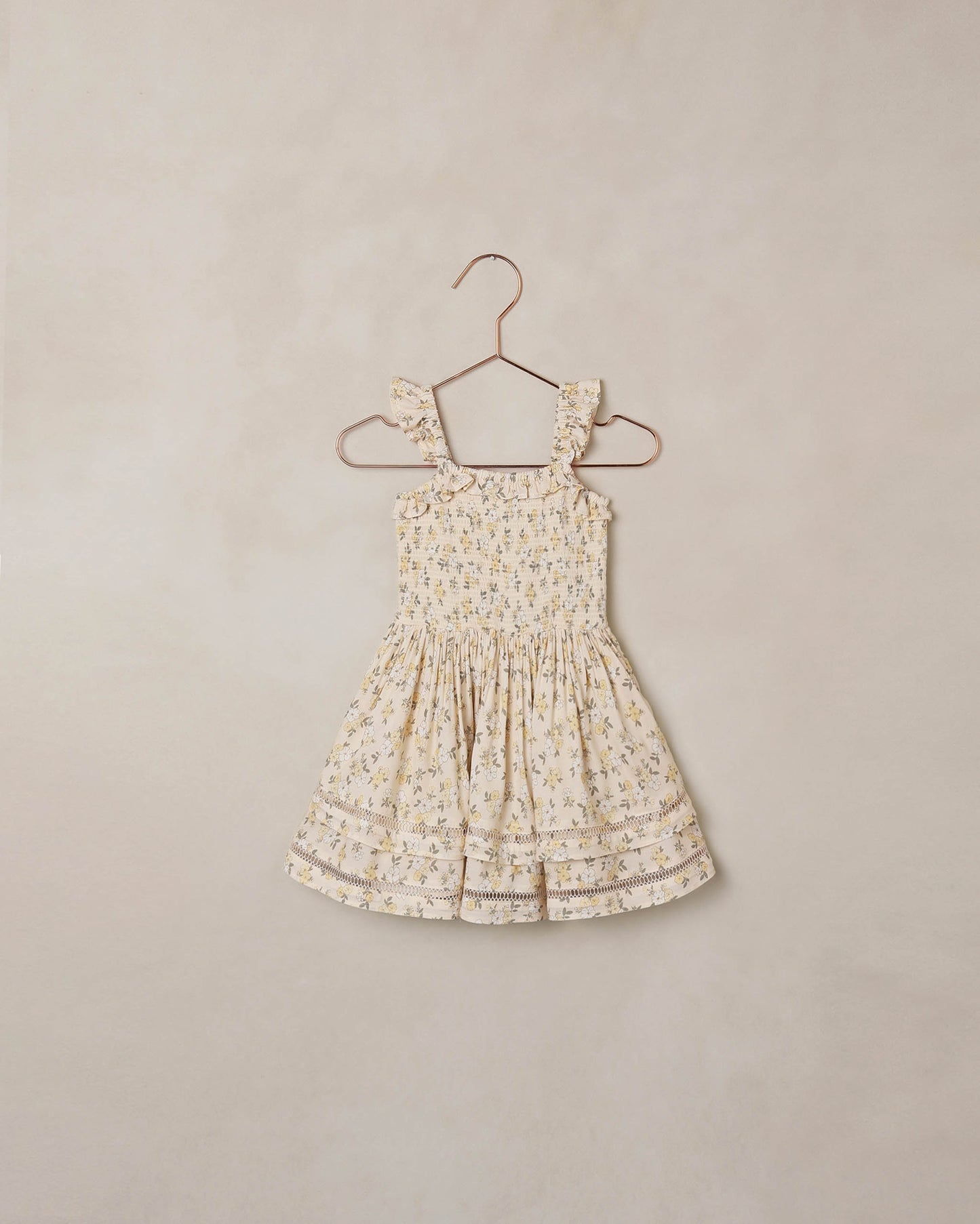 Natural-colored Lemon Meadow Birdie Dress by Noralee, featuring a floral pattern and lightweight fabric, displayed on a model.