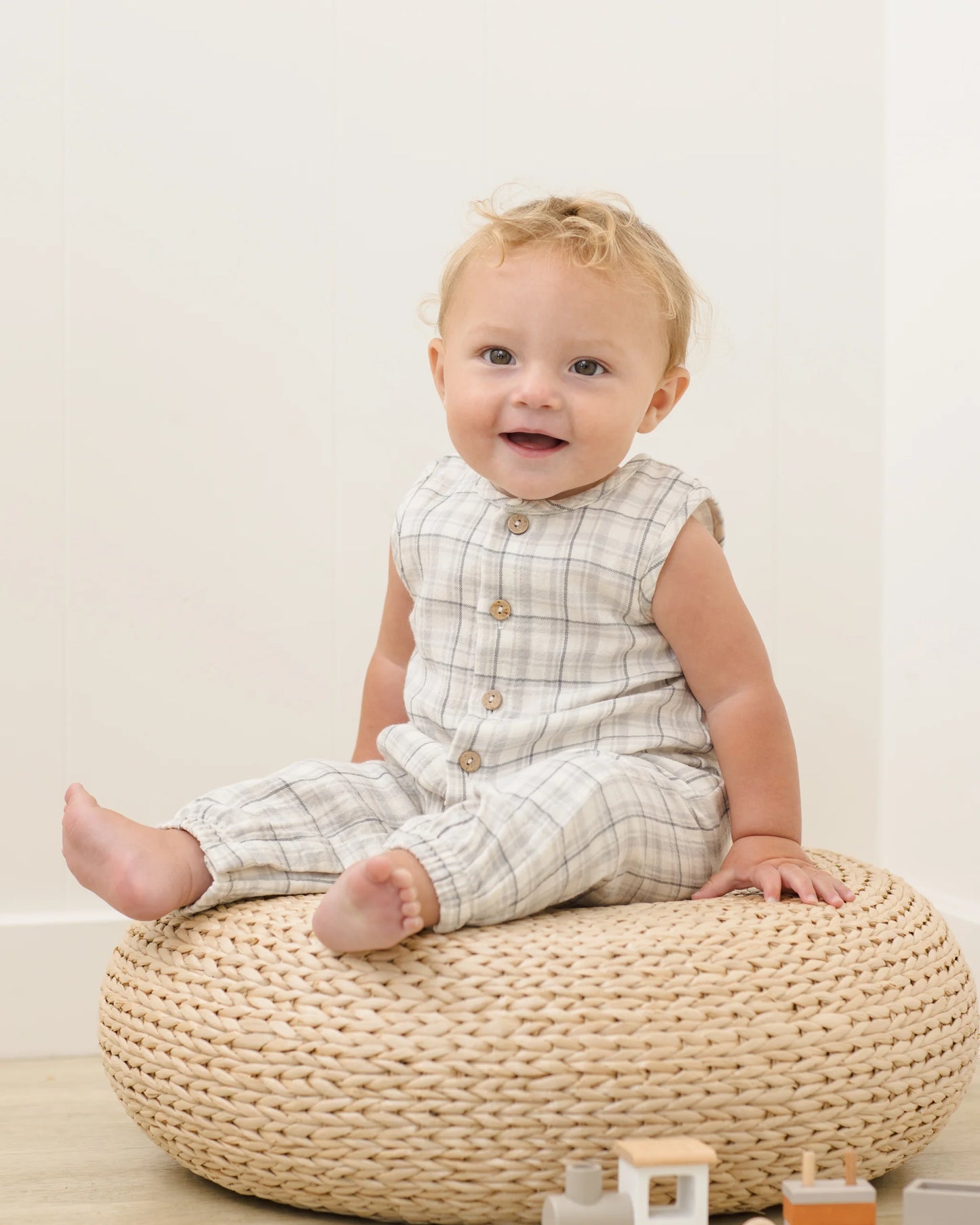 Blue plaid woven jumpsuit by Quincy Mae, shown as a comfortable, stylish one-piece outfit in a lifestyle setting.