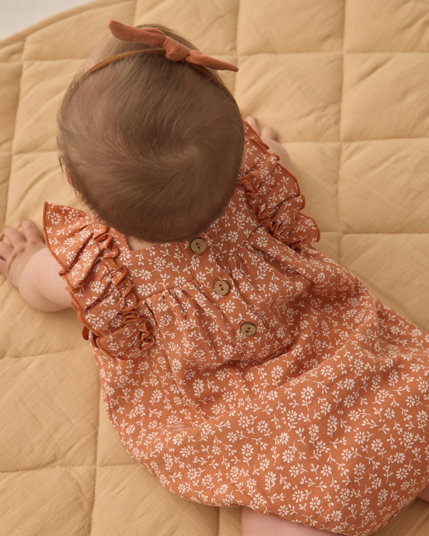 Quincy Mae Poppy Floral Maya Romper in vibrant spring colors, featuring a floral pattern and lightweight, comfortable fabric.