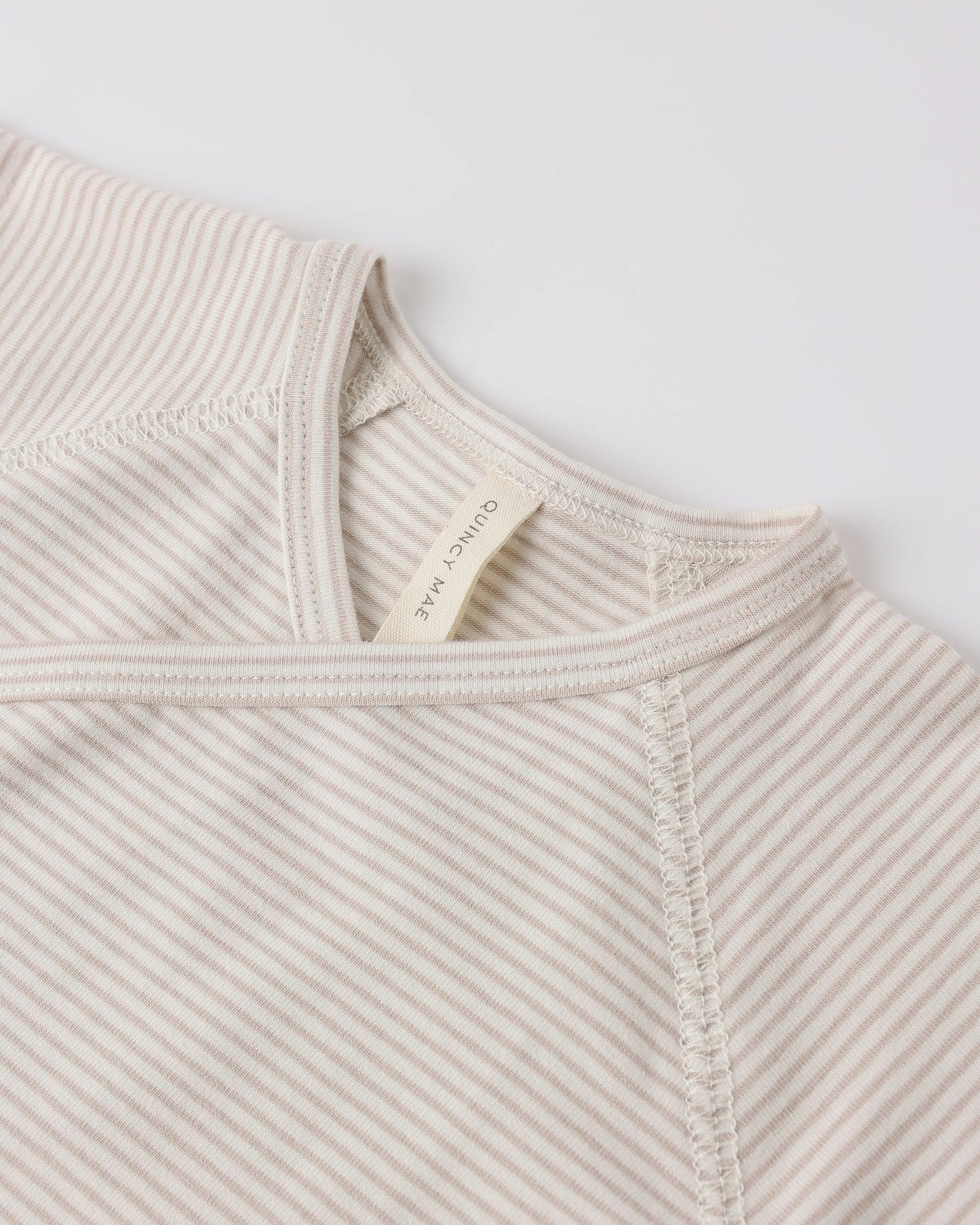 Quincy Mae oat micro stripe wrap top with matching footed pants set, featuring soft fabric and comfortable fit.