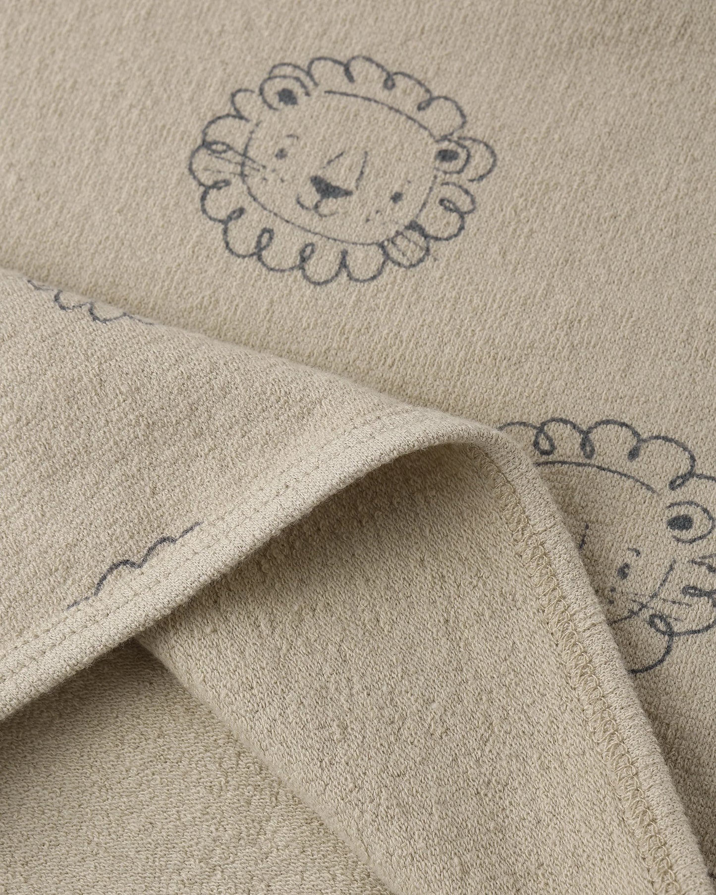 Lion Darla Dress by Quincy Mae, oatmeal-colored dress with lion print and ruffled details, suitable for young children.
