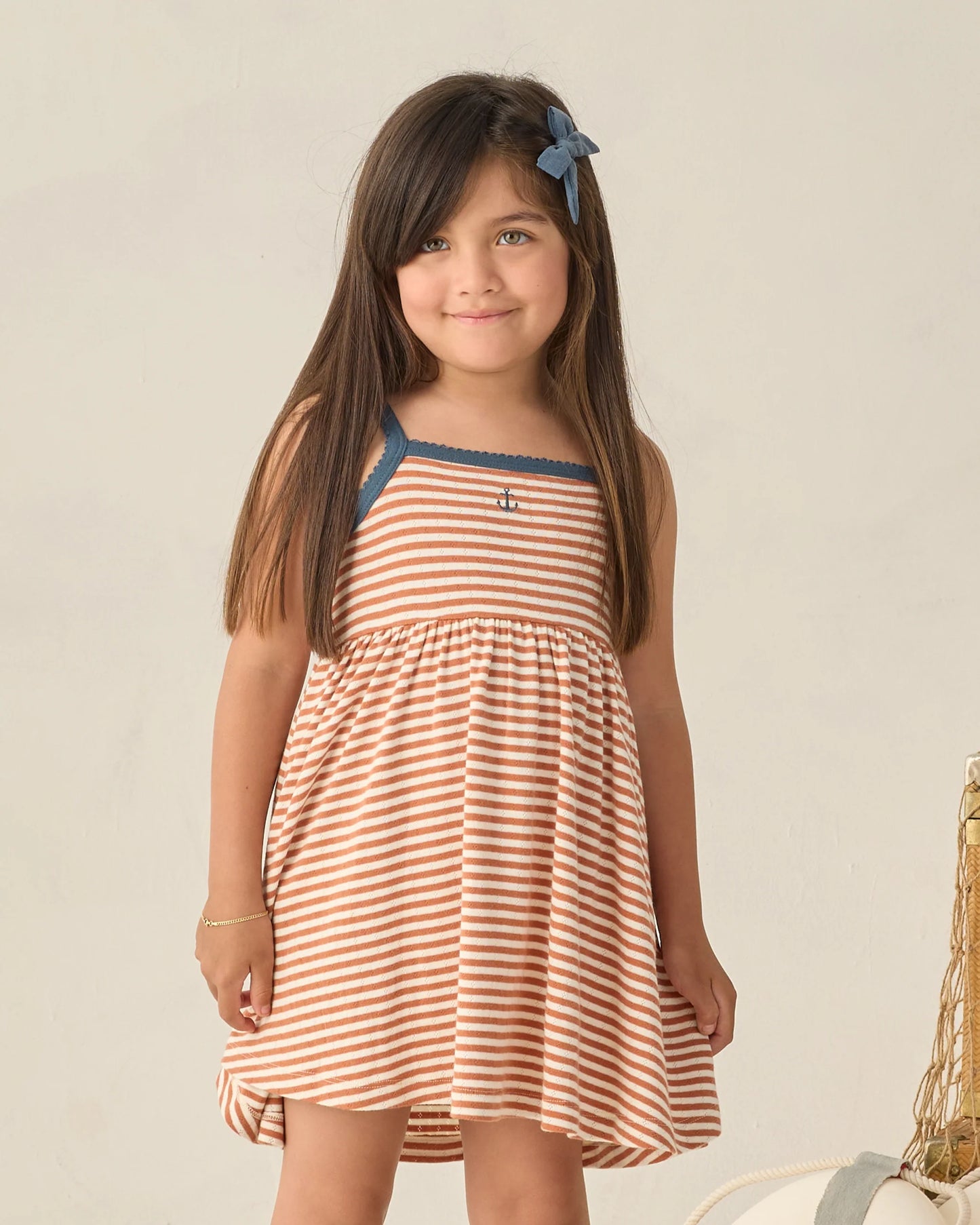 Rylee & Cru Poppy Stripe Lea Dress for girls with colorful striped pattern and ruffle details, displayed on a hanger.