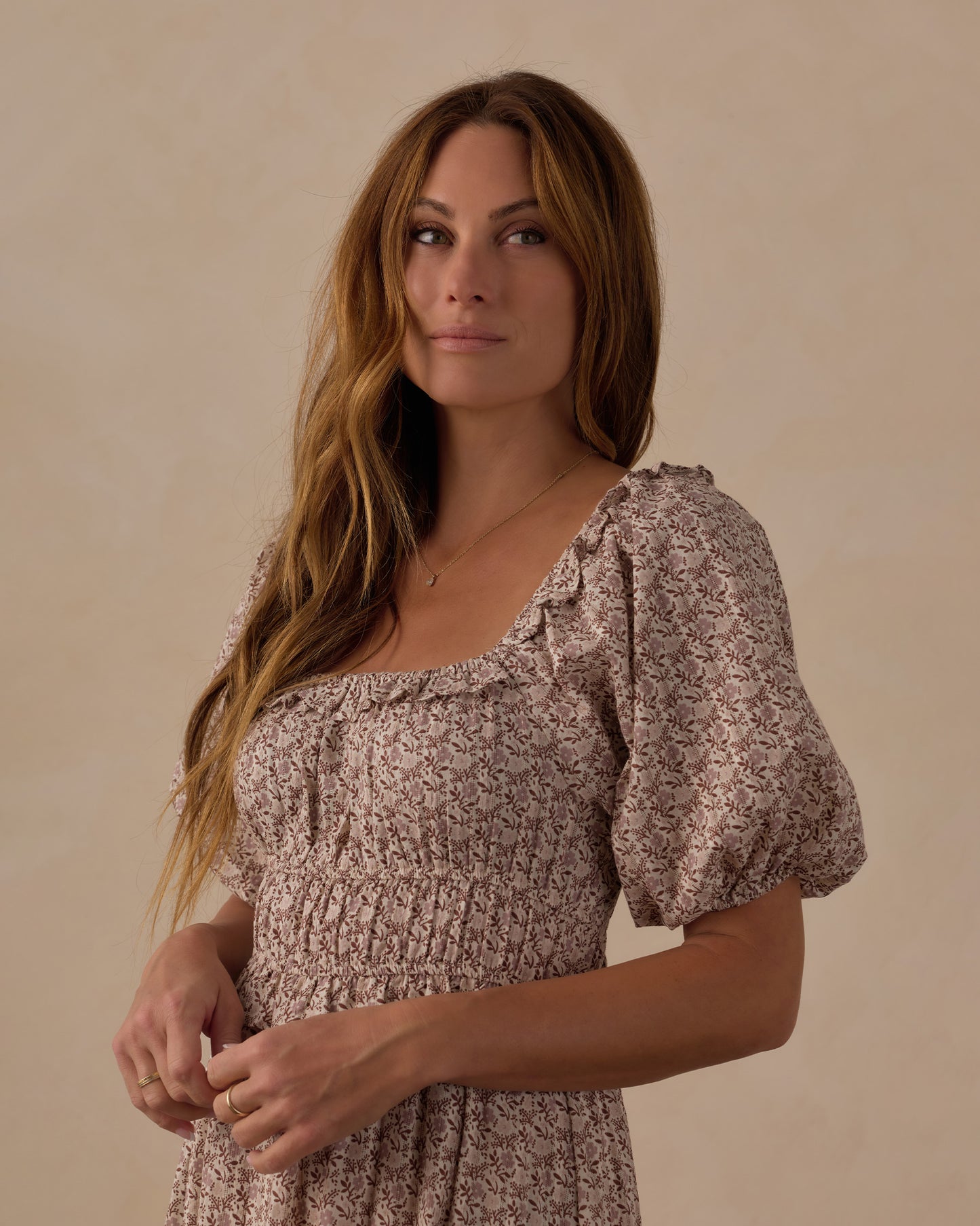 Women's Primrose Tenley Dress by Rylee & Cru, featuring a floral pattern and flowing fabric, displayed on a hanger.
