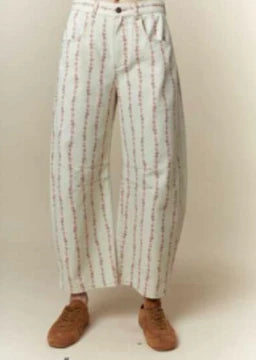 Pink and cream floral denim barrel pants by Peach Love California featuring a stylish floral pattern and relaxed fit.
