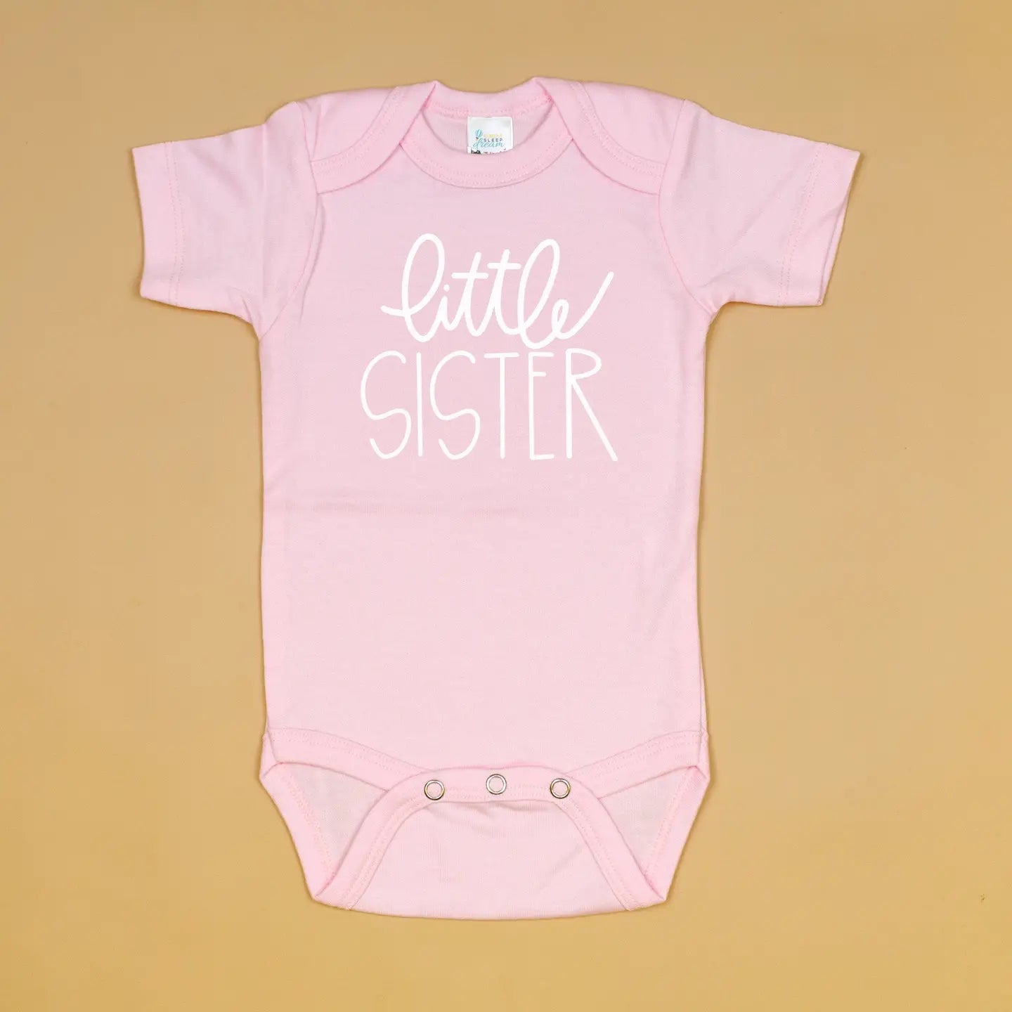 Little sister pink onesie by Cuddle Sleep Dream, soft fabric with cute design, perfect for newborns and infants.