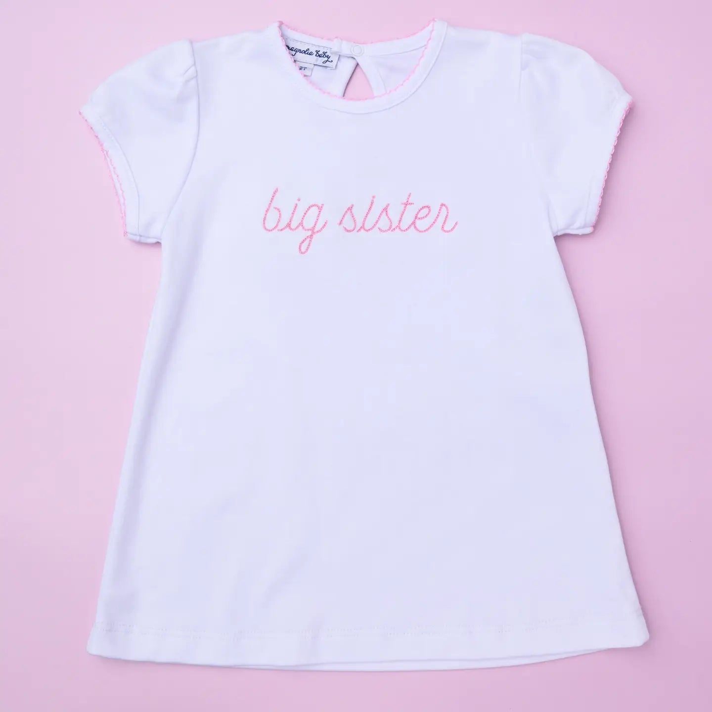Pink embroidered "Big Sister" Magnolia Baby T-shirt with floral design for young girls, casual and comfortable.