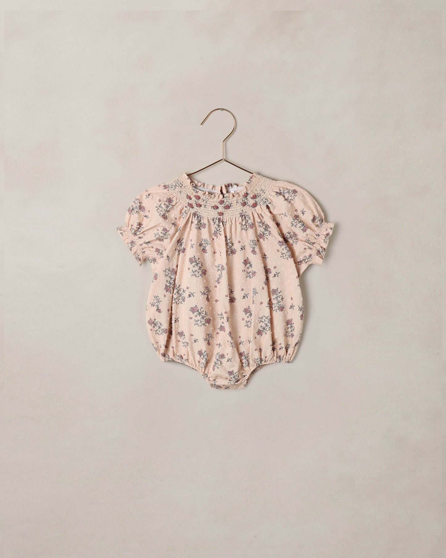 Noralee French Floral Maddie Romper displayed on a model, featuring a lightweight fabric with a delicate floral pattern.