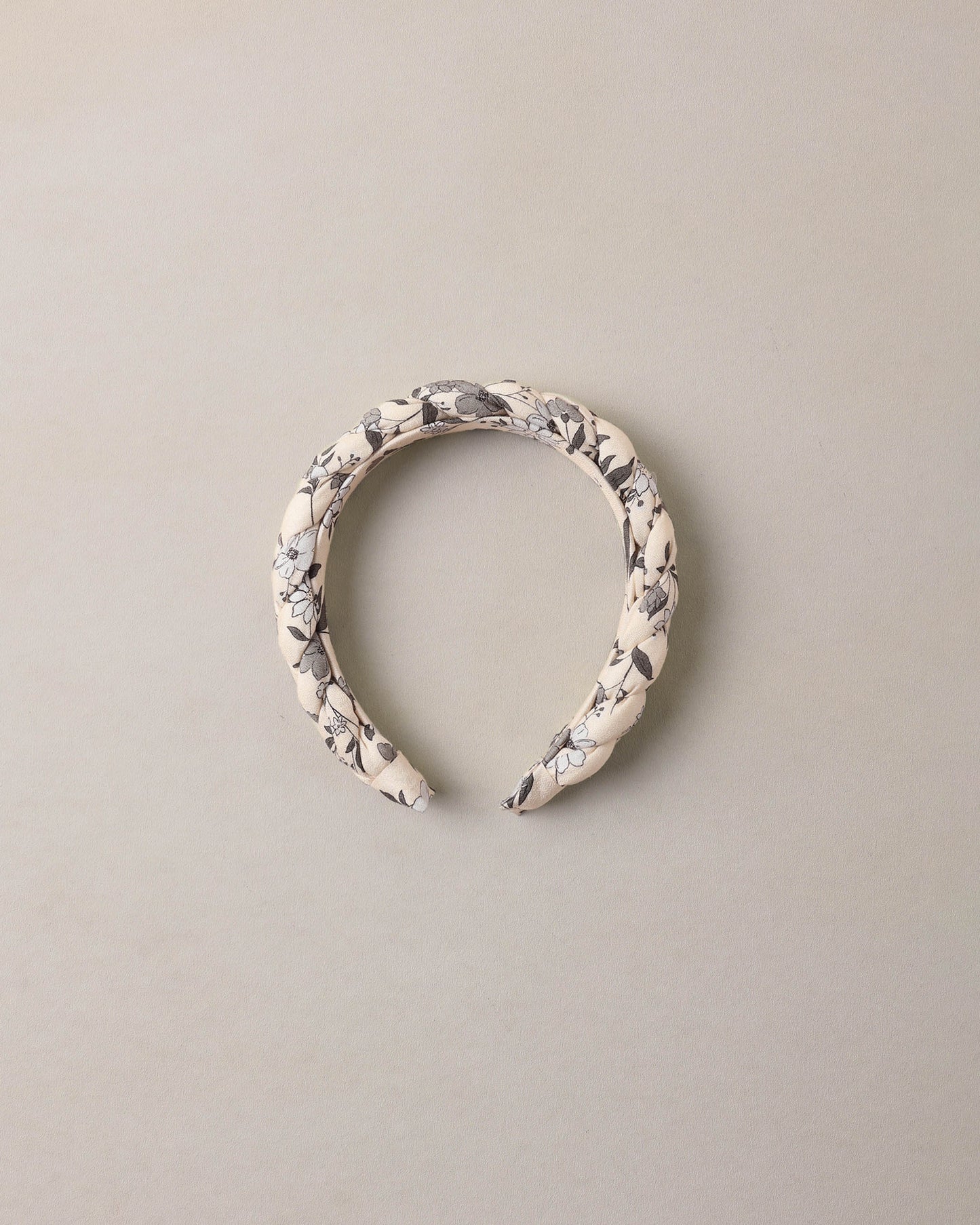Blue braided garden headband by Noralee, featuring woven fabric with floral-inspired design and casual styling.
