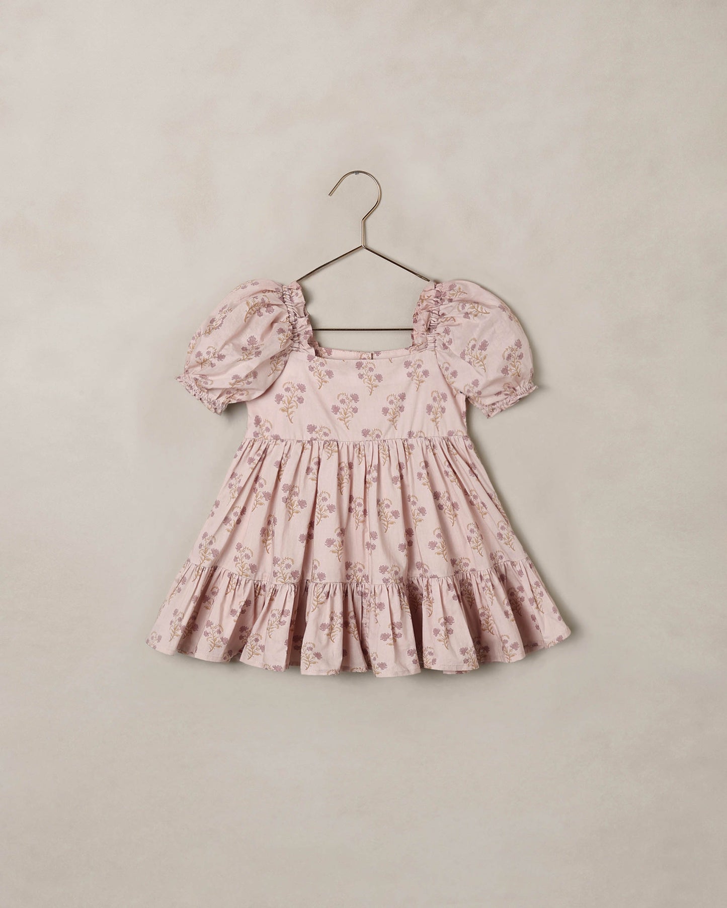 Noralee Florentine Louella Dress shown on a mannequin with floral patterns and flowing fabric, perfect for summer occasions.