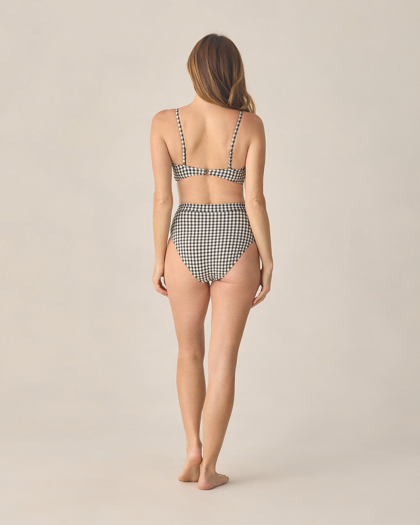 Women's black gingham bandeau bikini top with knotted front from Rylee & Cru, featuring a stylish and supportive swimwear design.