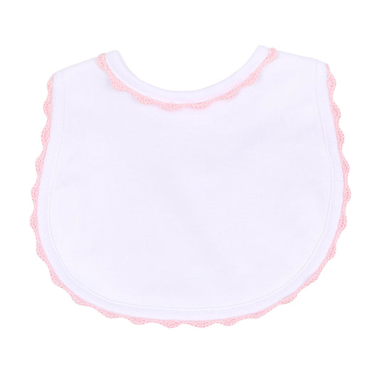 Magnolia Baby Baby Joy pink crochet trim bib with soft fabric and decorative lace for baby girls.