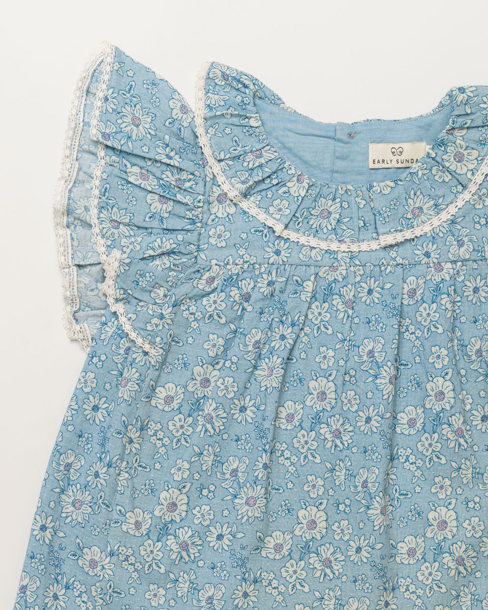 Blue floral baby dress with matching bloomer from Early Sunday, featuring a delicate pattern and soft, comfortable fabric.