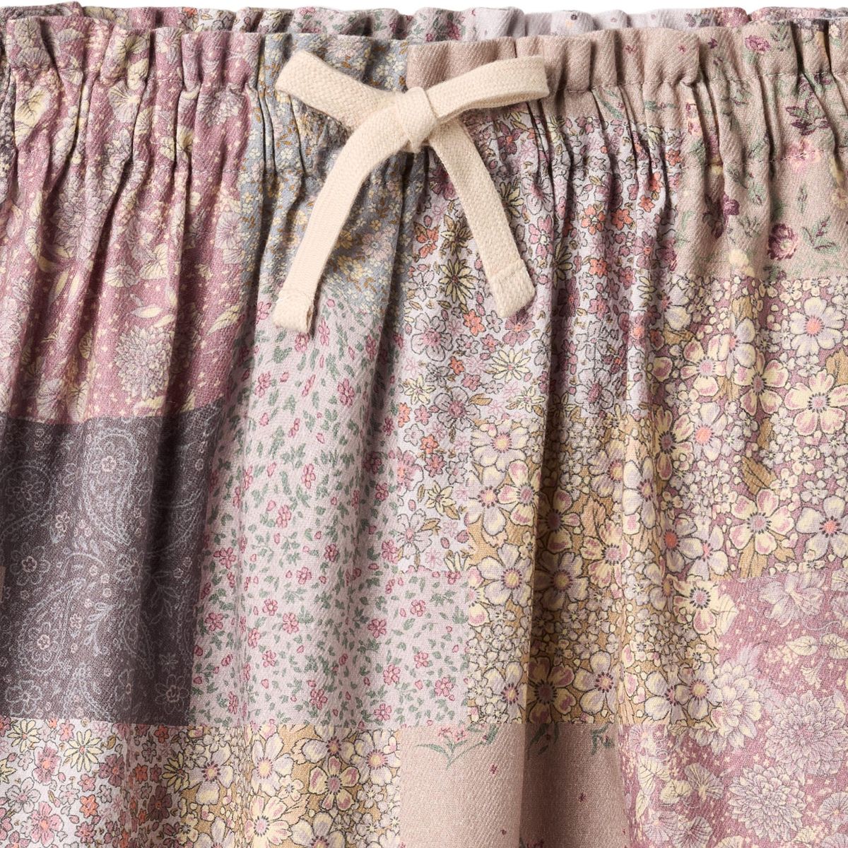 Wheat Patchwork Flowers Nya Skirt featuring colorful floral patchwork design and a flowing, stylish silhouette.