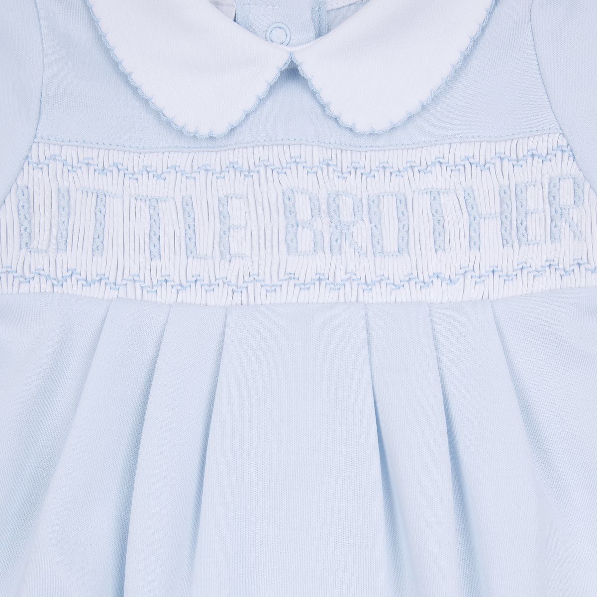 Light blue Magnolia Baby little brother smocked footie with embroidery and ruffled trim, designed for infants.