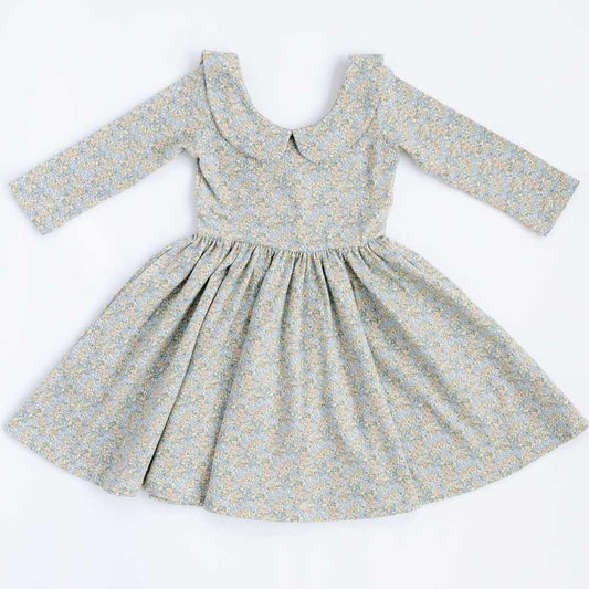 Blue watercolor floral twirl dress with 3/4 sleeves and a collar by Good Apples, shown on a model.