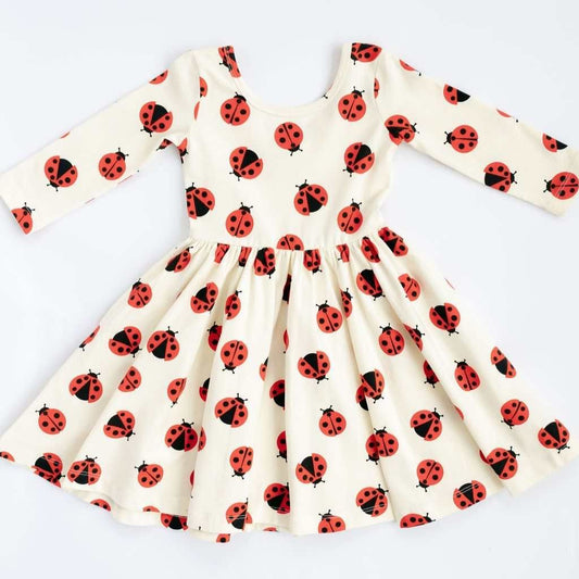 Good Apples 3/4 sleeve twirl dress for girls featuring a playful ladybug print and a fun, twirling skirt.