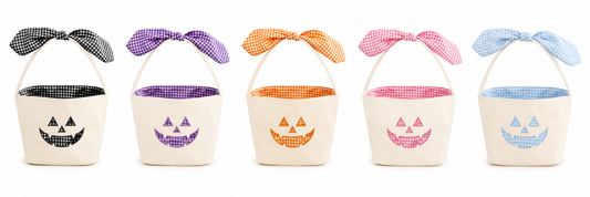 Zsa Zsa Lolli pumpkin face basket with orange handle and carved pumpkin design, ideal for trick-or-treating or fall decor.