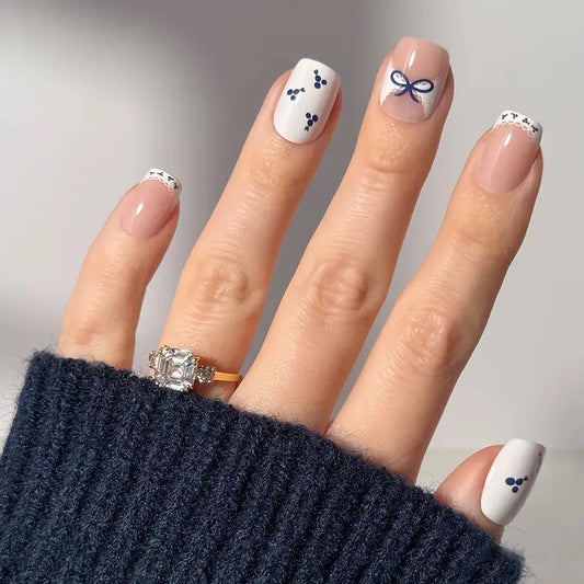 Blue A Kiss press-on nails by Glamnetic in short squoval shape, showcasing glossy blue finish and natural-looking design.