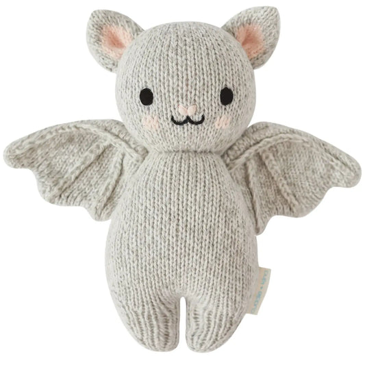 Grey baby bat plush from cuddle + kind featuring soft fabric and detailed bat wing design, perfect for cuddling and play.