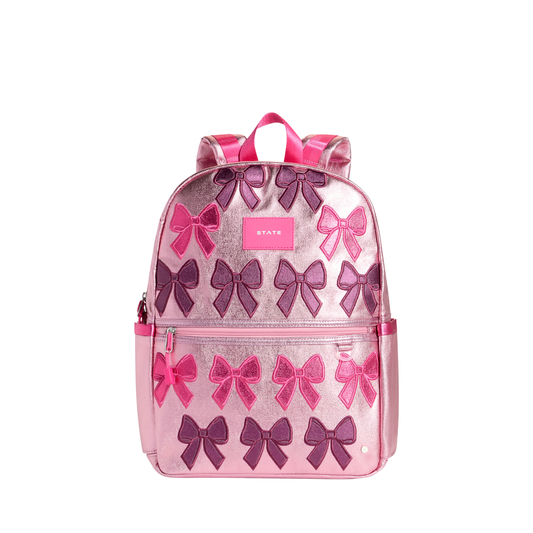 Patchwork Bow Kane Backpack by State Bags featuring a colorful patchwork design and bow detail on the front.