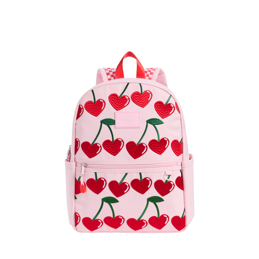 Cherry Kane backpack by State Bags, featuring a vibrant cherry print design with adjustable straps and multiple compartments.
