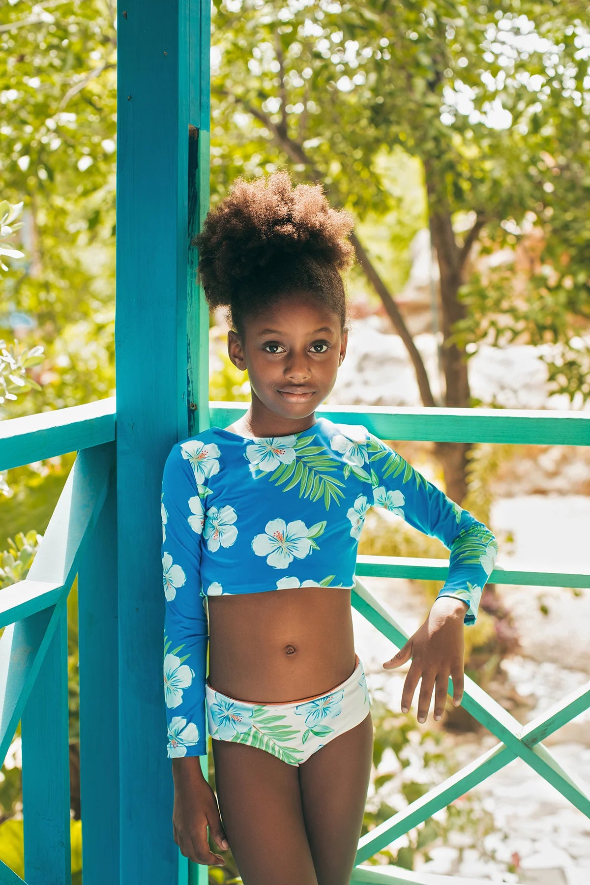 Hibiscus Azul Sun Bikini by Pepita & Me featuring a vibrant blue hibiscus floral pattern and bikini top and bottom.