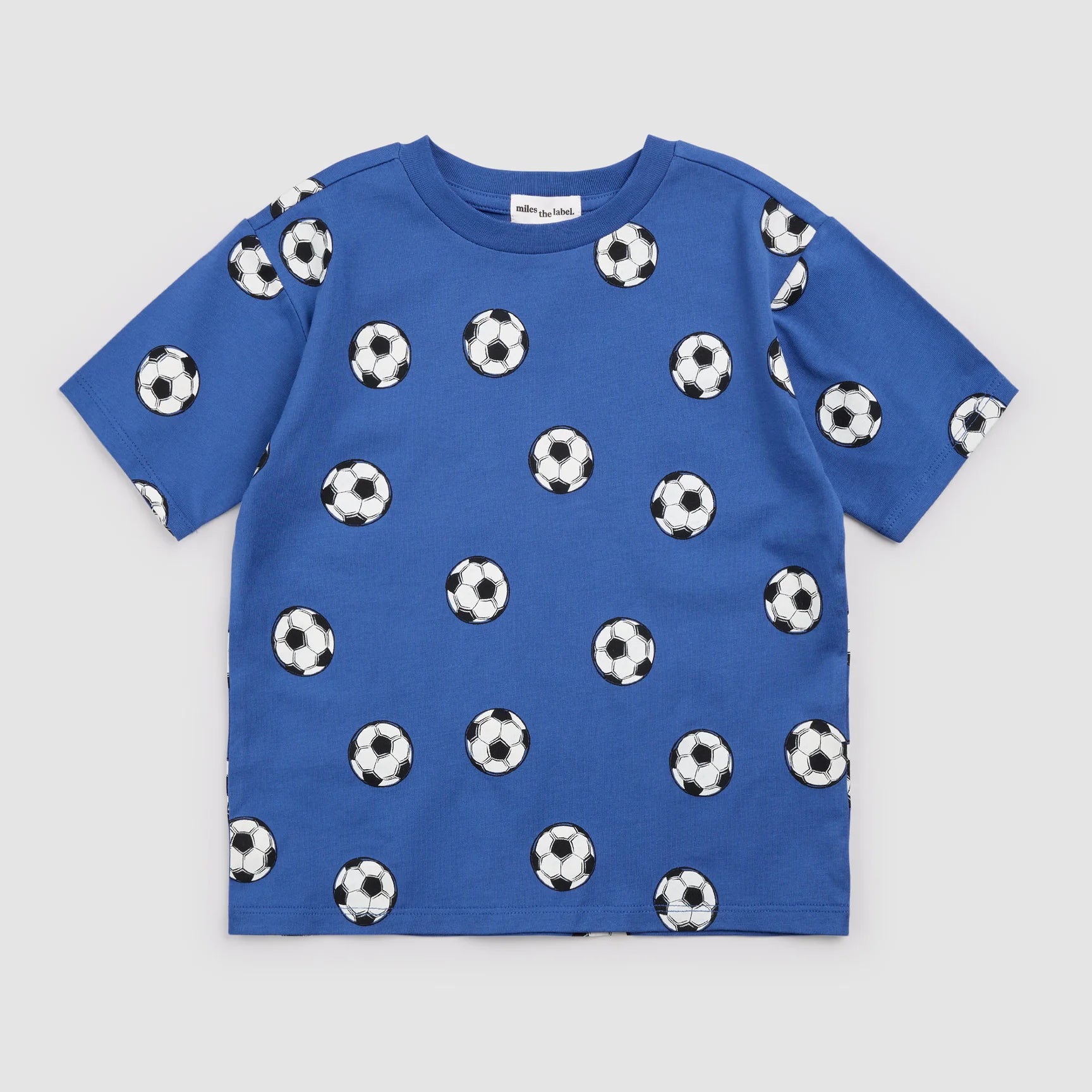 Royal blue soccer print shirt by Miles the Label featuring bold soccer-themed graphics on lightweight fabric.