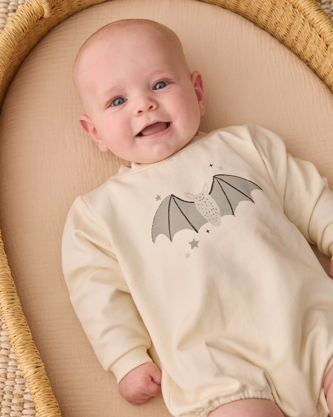 Baby Quincy Mae Bat Crewneck Bubble Romper laid flat, showing soft fabric, bat motif, and cozy crewneck design for infants.
