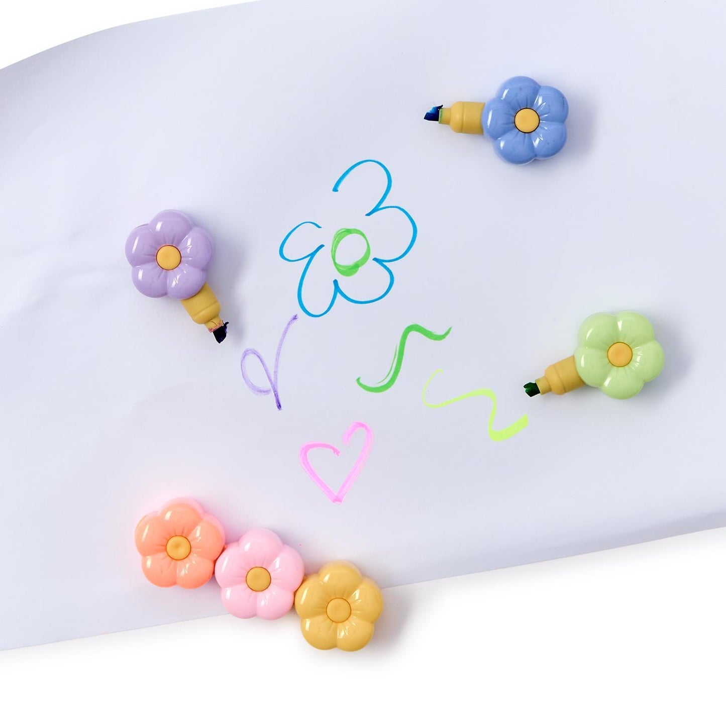 Stackable Flower Power highlighters in vibrant colors, featuring flower-shaped tips, by Twos Company.