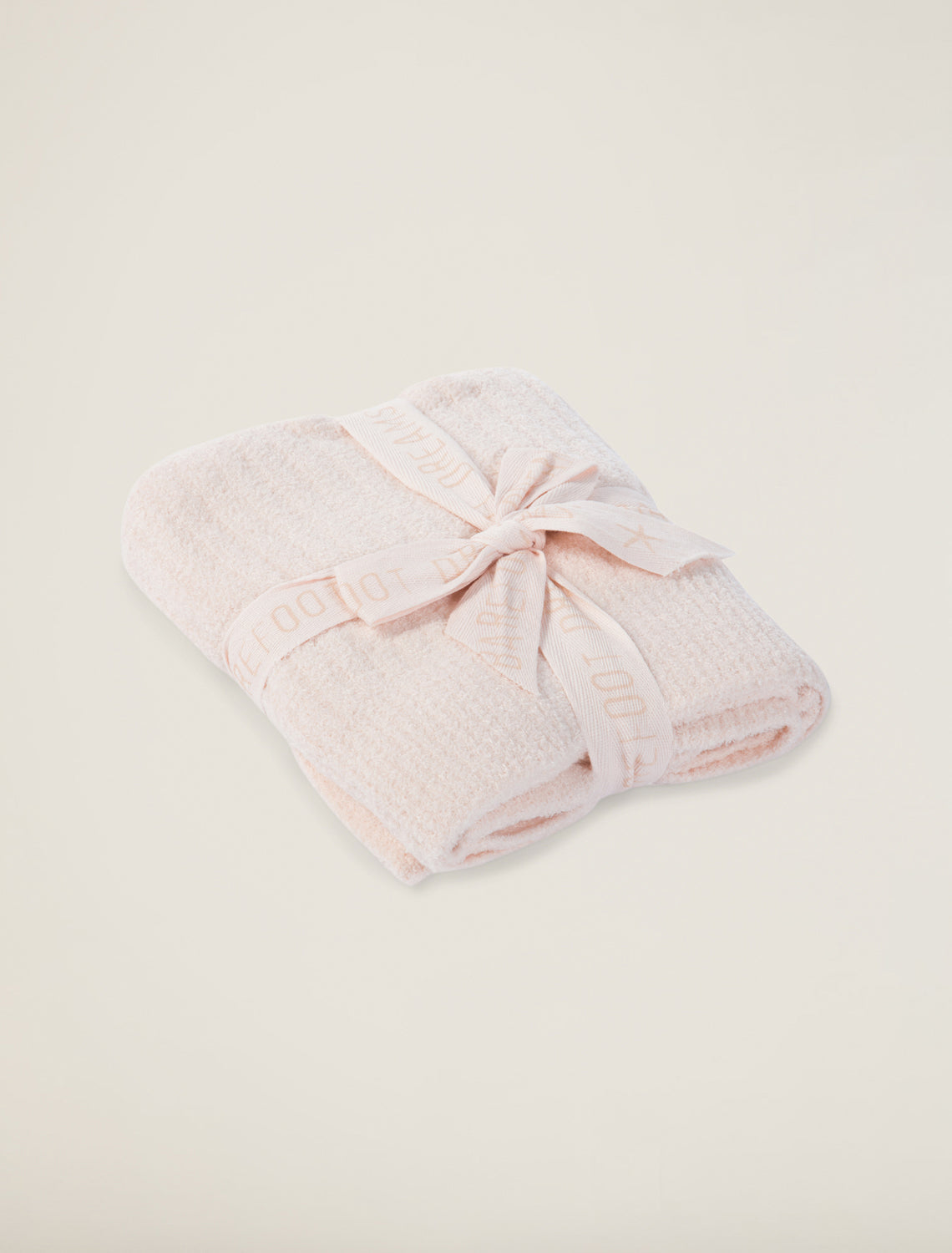 Pink Barefoot Dreams Cozychic Lite ribbed baby blanket with soft, cozy fabric and textured ribbed pattern.