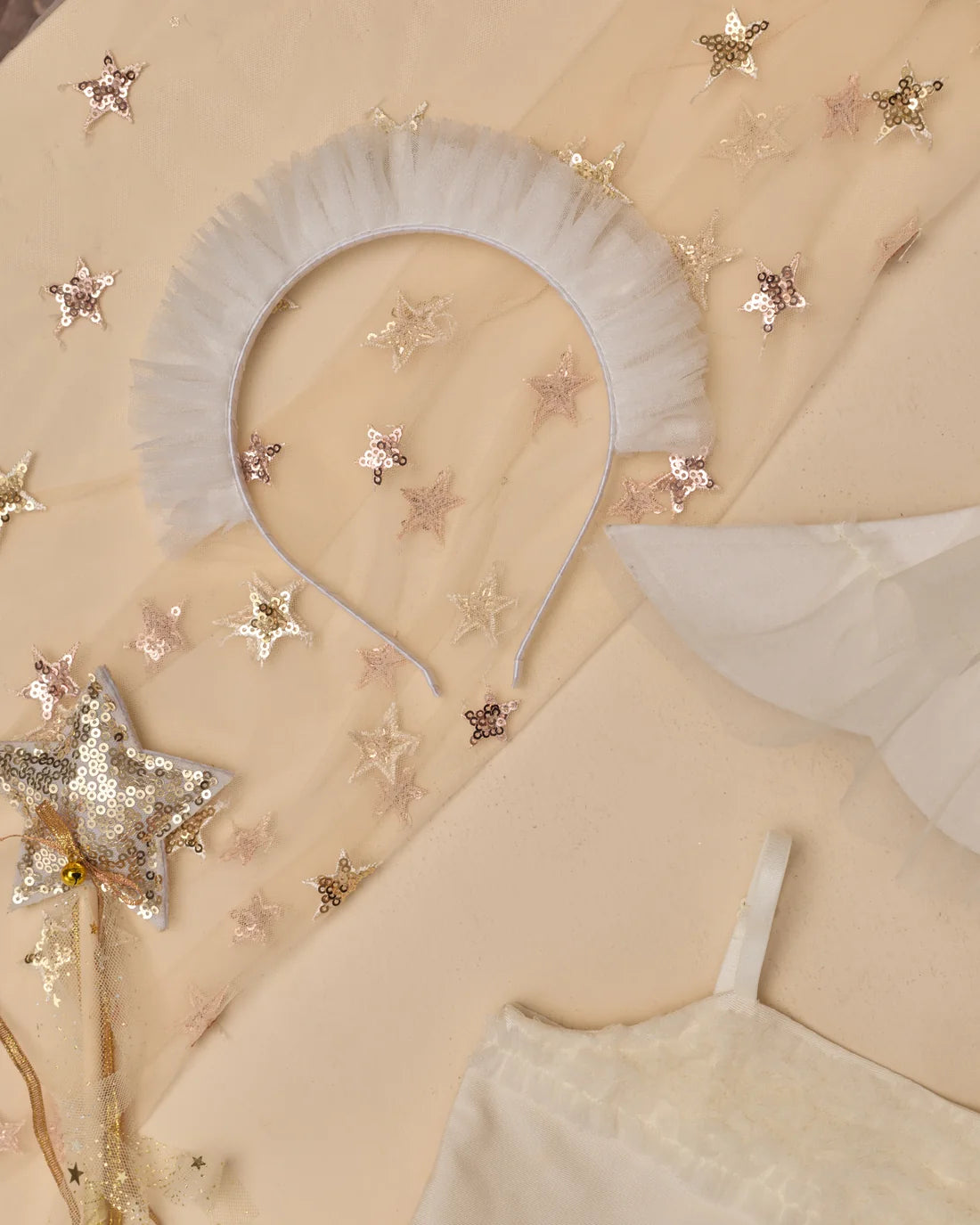 Ivory Noralee ruffle headband with soft fabric and decorative ruffles, perfect for stylish accessories or baby and toddler hairwear.