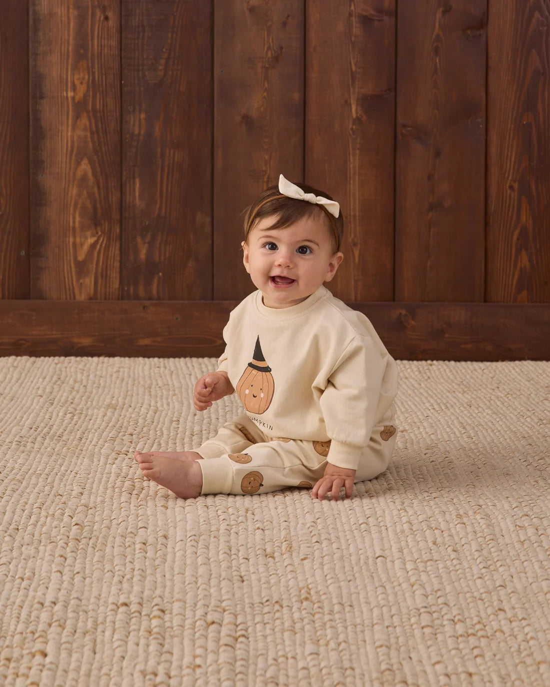 Quincy Mae Lil Pumpkin relaxed fleece sweatshirt in soft orange with a cozy fit and pumpkin graphic design.