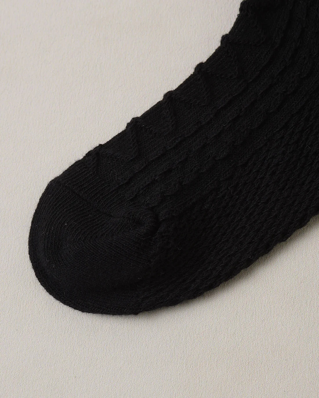 Black and blush ruffle socks by Noralee with soft fabric and frilled edges, displayed laid out flat.