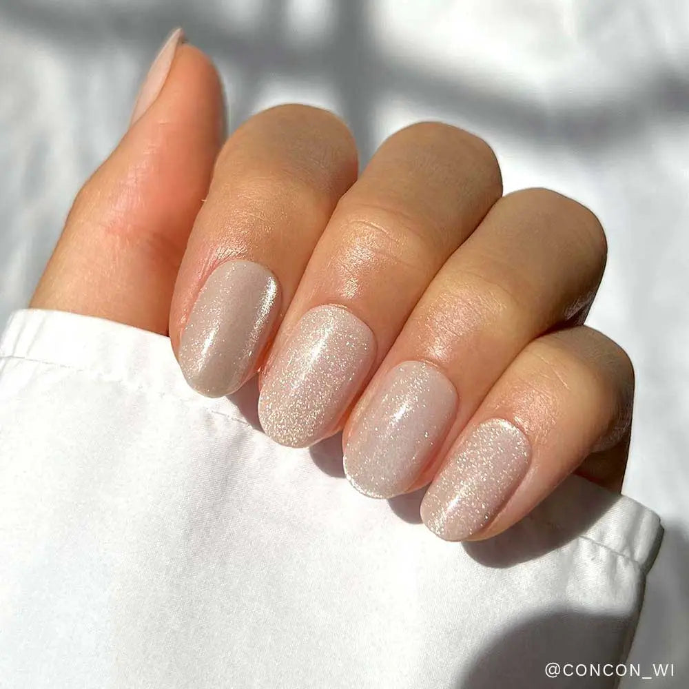 Glamnetic Pure Intentions iridescent press-on nails with a shiny, reflective finish and natural oval shape.