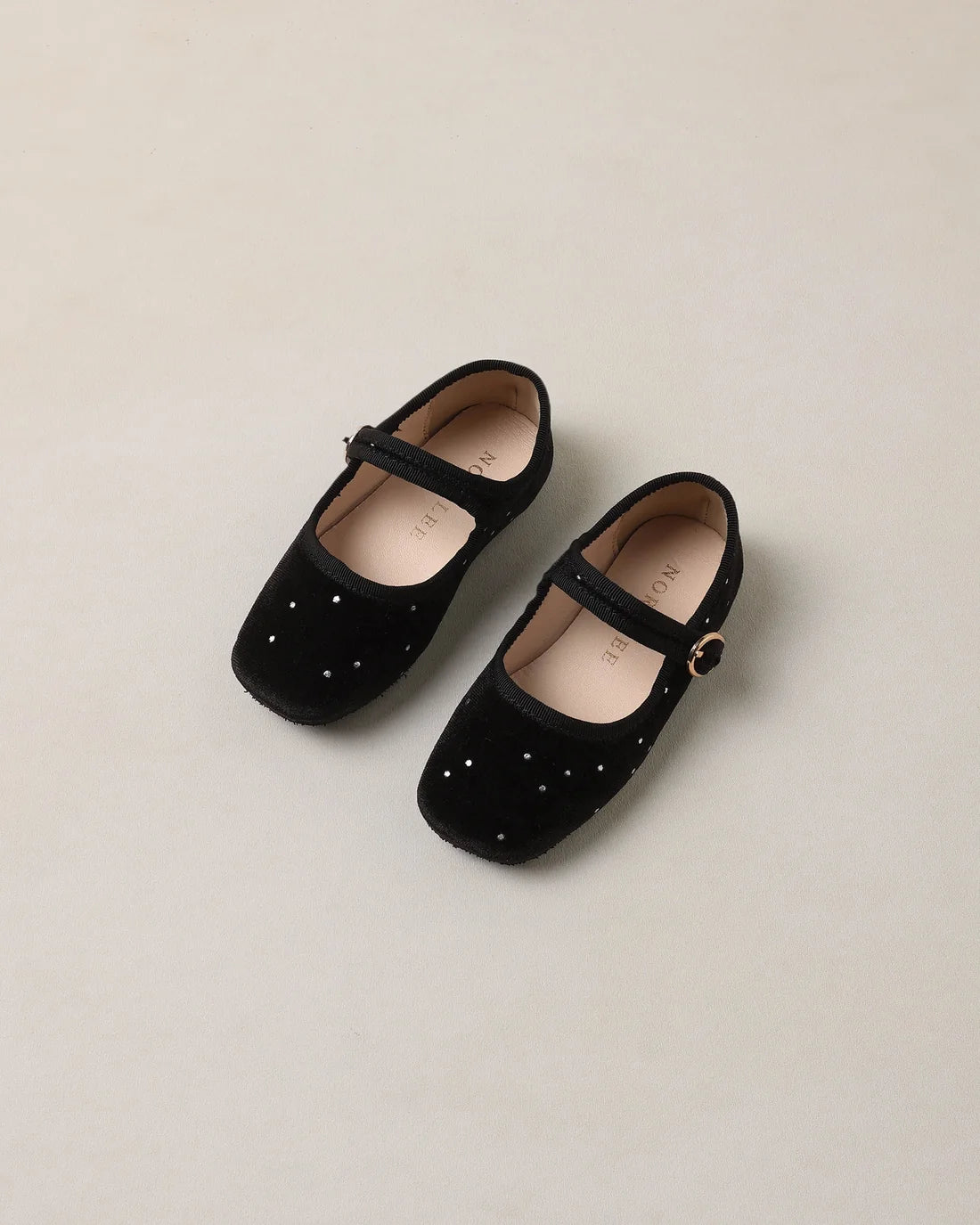 Black strap ballet flats by Noralee featuring a classic design with a comfortable fit and elegant style.