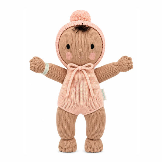 Cuddle + Kind My First Baby Peach plush toy with soft, textured fabric and embroidered facial features, designed for infants.