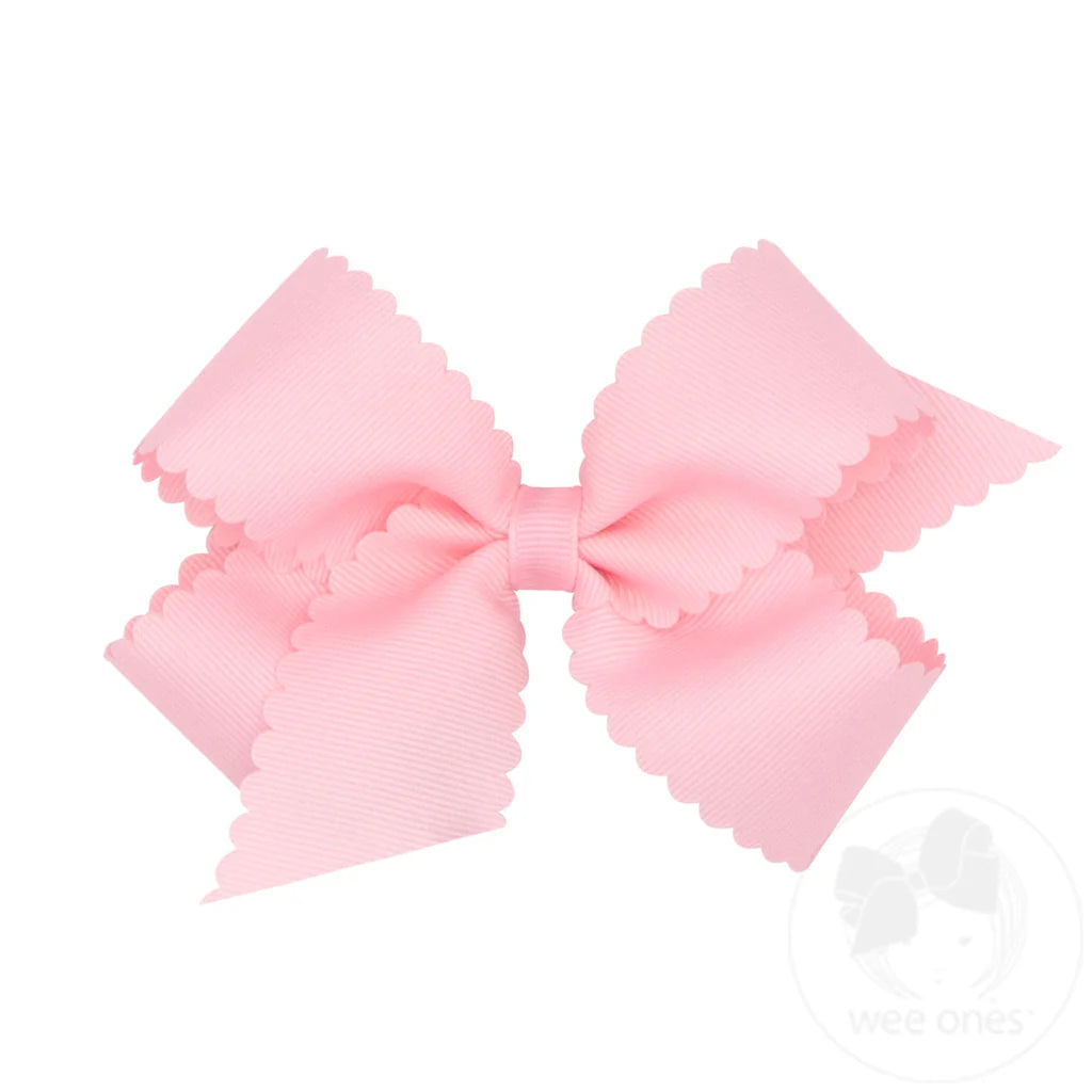 Medium grosgrain hair bow with scalloped edge in light pink, designed for young children, by wee ones.