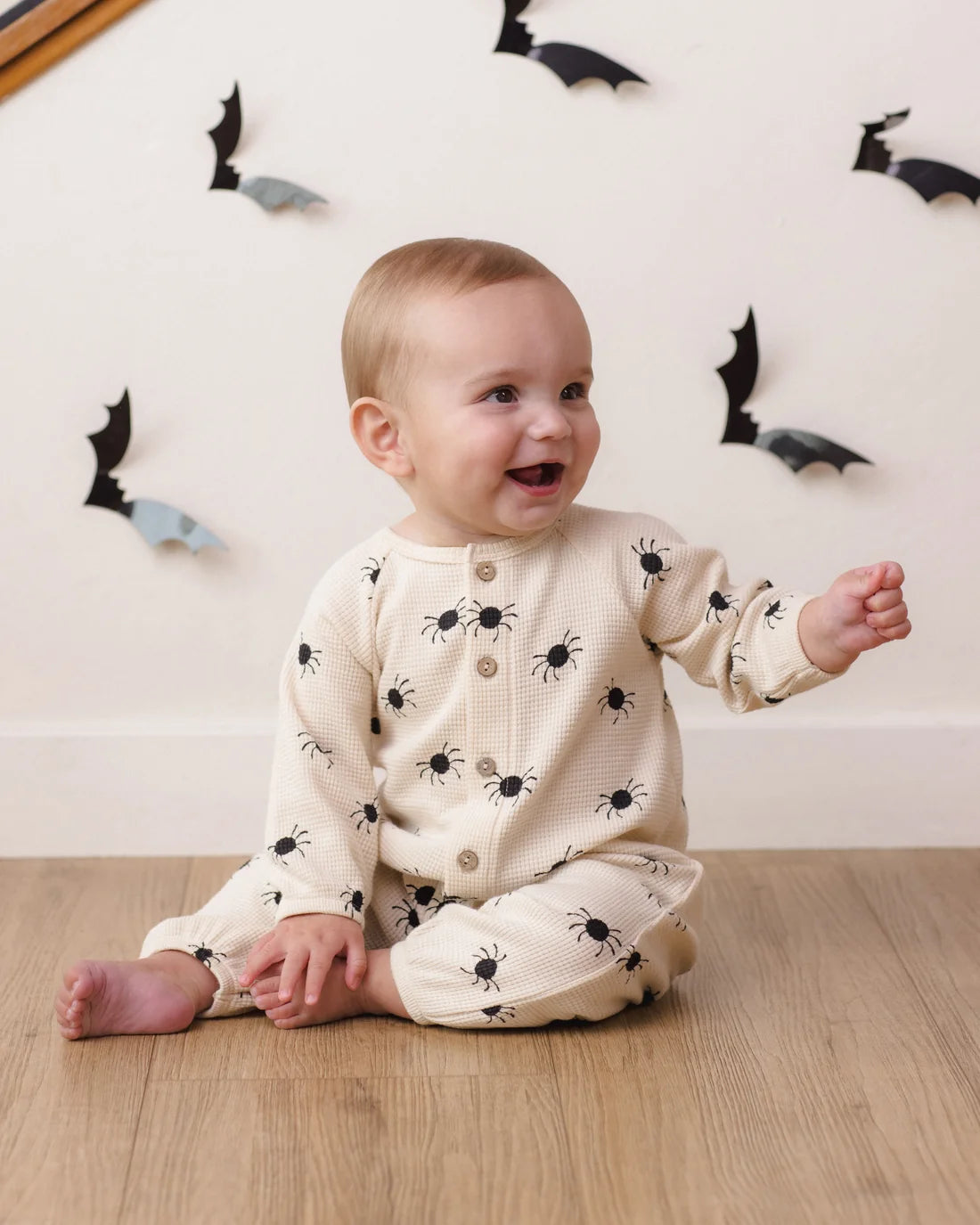 Quincy Mae Bitsy Spider waffle long sleeve jumpsuit for babies, featuring soft fabric and adorable spider print design.