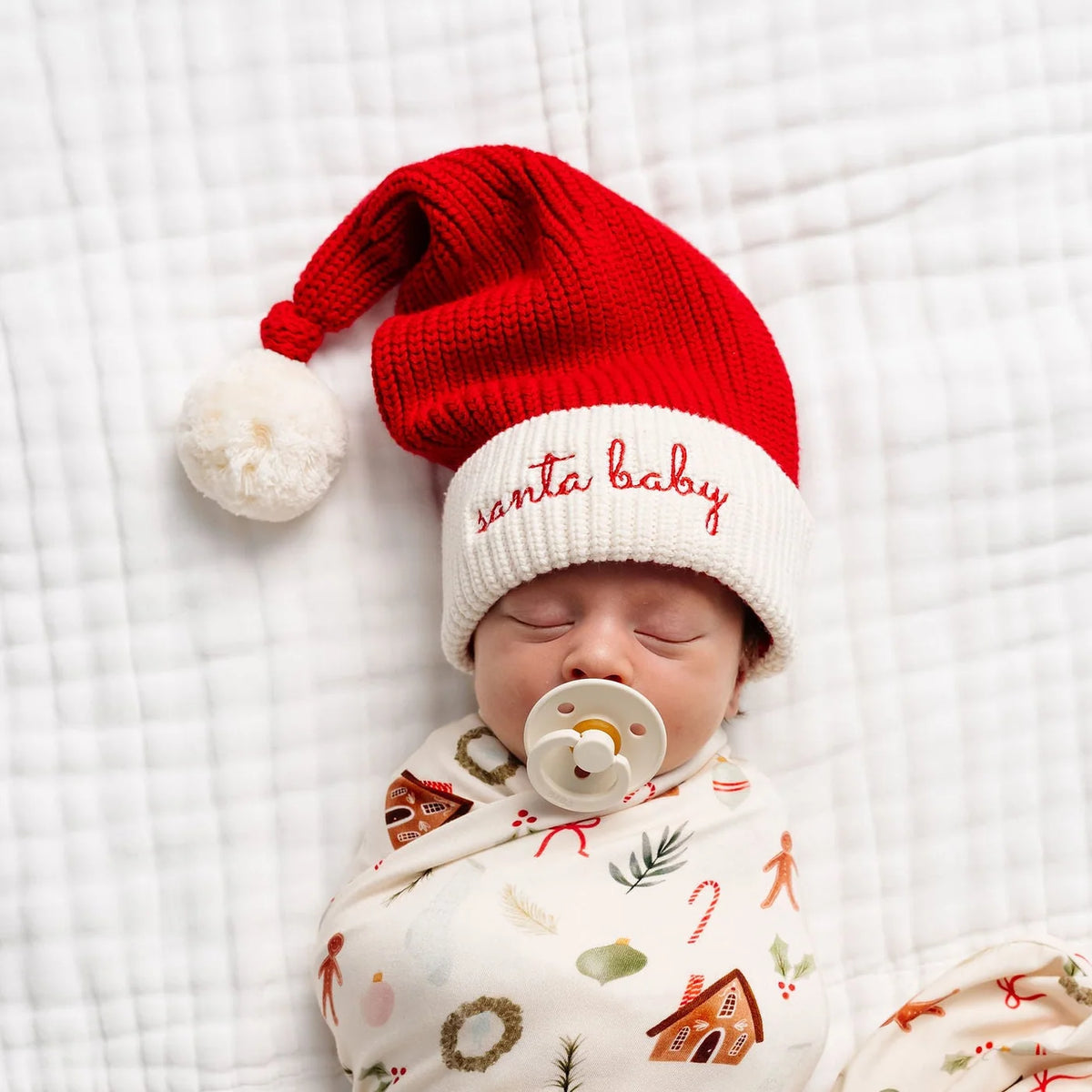 Lou Lou & Co Santa Baby embroidered beanie featuring festive red knit with a playful Christmas-themed design.