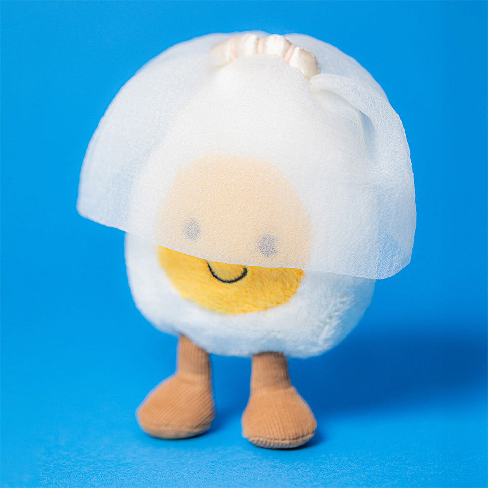 Jellycat Amuseables Boiled Egg Bride plush toy with soft white and yellow fabric, wearing a wedding veil and bow, cuddly and cute.