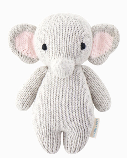 Soft plush baby elephant toy by cuddle + kind, featuring gray fur and gentle eyes, designed for infants and young children.