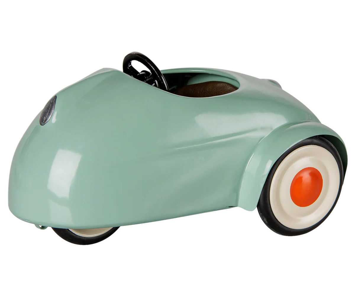Maileg light mint-colored mouse toy in a car-shaped design, perfect for children's play and imaginative adventures.