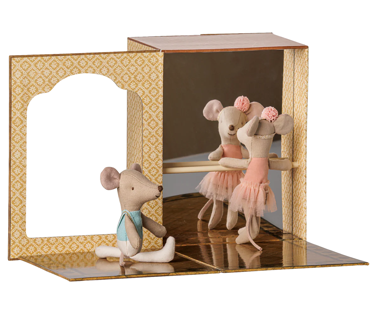 Maileg ballet mice siblings in a dance studio, dressed in ballet costumes, practicing dance moves together.